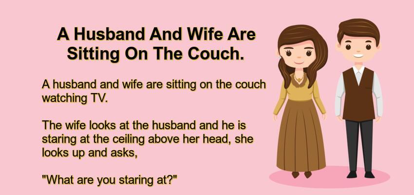 A Husband And Wife Are Sitting On The Couch.